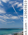 Blue sky with contrails and turquoise sea 129049819