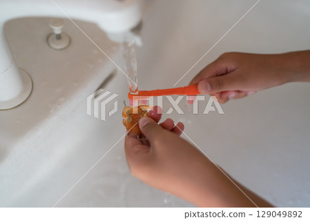 A child brushing orthodontic appliances (expansion plates) with a toothbrush A child brushing orthodontic appliances (expansion plates) with a toothbrush 129049892