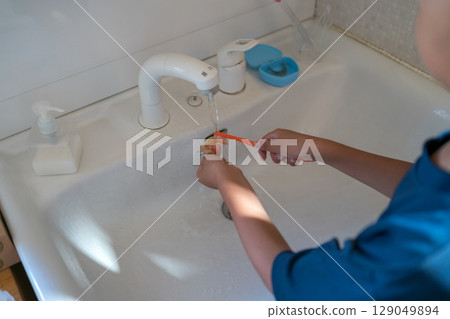 A child brushing orthodontic appliances (expansion plates) with a toothbrush A child brushing orthodontic appliances (expansion plates) with a toothbrush 129049894