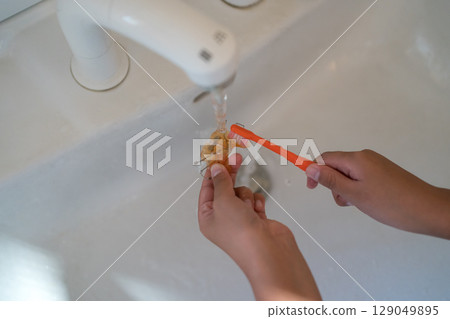 A child brushing orthodontic appliances (expansion plates) with a toothbrush A child brushing orthodontic appliances (expansion plates) with a toothbrush 129049895