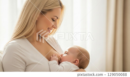Blonde woman breastfeeding her baby 129050088