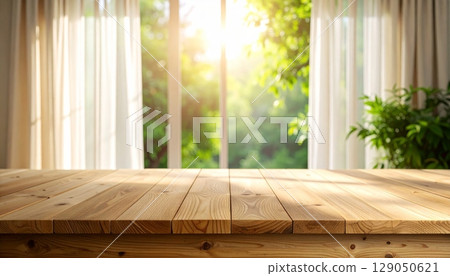 Bright, empty wooden table with a sunlit window view in a rustic interior room 129050621
