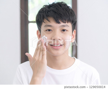 AI-generated image of a young Japanese boy washing his face with foam 129050814