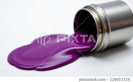 Purple paint spilling from tipped metal container on white surface, showing smooth glossy texture and vibrant color 129051329