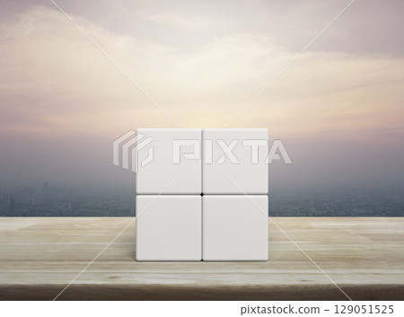 Four white block cubes on wooden table Four white block cubes on wooden table 129051525