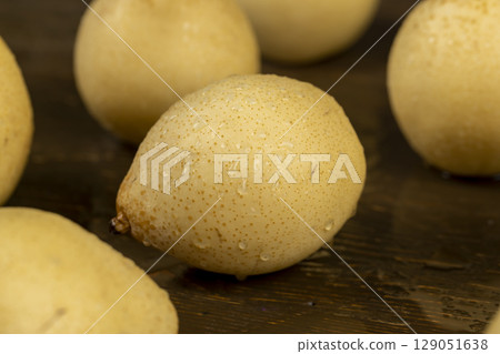 wet sweet pears of white color with spots on the skin closeup wet sweet pears of white color with spots on the skin closeup 129051638