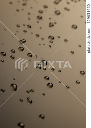 water makes the waterproof smooth surface completely wet, part of the phone screen is covered with drops of water, close up 129051660
