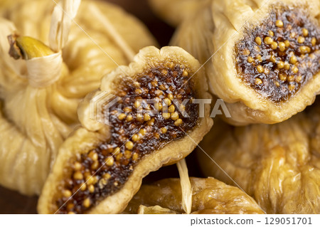 cut dried figs closeup, figs with seeds naturally dehydrated in the sun and cut into pieces cut dried figs closeup, figs with seeds naturally dehydrated in the sun and cut into pieces 129051701