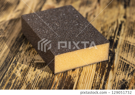 wooden board made of pine planks for polishing with sandpaper on the construction site 129051732