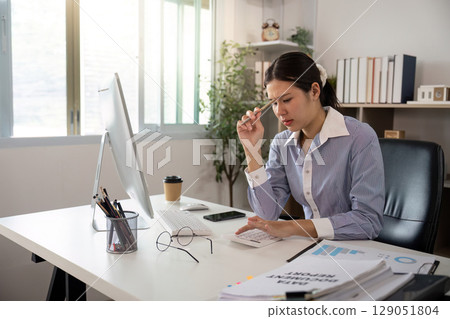 Office Syndrome: Stressed Woman at Desk with Headache 129051804