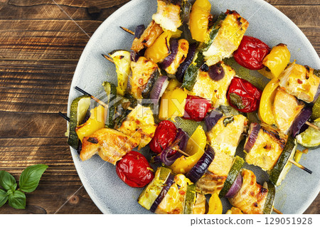 Fish shashlik with vegetables on rustic wooden table. 129051928