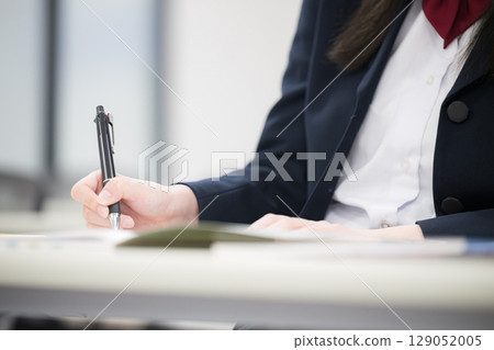 Female high school student studying during school or cram school classes. Spring, autumn and winter, wearing a blazer. Close-up of hands, no face. Female high school student studying during school or cram school classes. Spring, autumn and winter, wearing a blazer. Close-up of hands, no face. 129052005