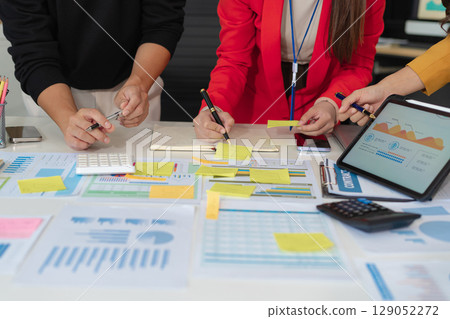 Businessmen team or financial data analysts working with tablets and laptop computers and data graphs together. Plan to analyzing projects in the office. Businessmen team or financial data analysts working with tablets and laptop computers and data graphs together. Plan to analyzing projects in the office. 129052272