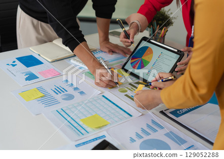 Businessmen team or financial data analysts working with tablets and laptop computers and data graphs together. Plan to analyzing projects in the office. 129052288