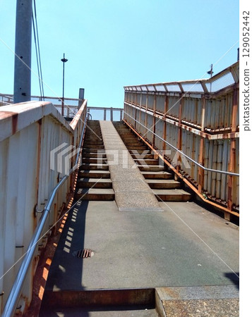 Summer scenery of an overpass on the Joban Line with rusty stairs Summer scenery of an overpass on the Joban Line with rusty stairs 129052442