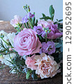Pink rose arrangement in a basket 129052695