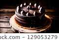 Decadent Dark Chocolate Cake with Glossy Ganache and Chocolate Decorations 129053279