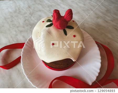 Festive dessert featuring decorative chicken atop a cake at a celebration event 129054893