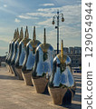 Art installation features shiny sculptures with golden crowns in city plaza 129054944