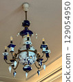 Elegant antique chandelier with blue accents in a vintage interior 129054950