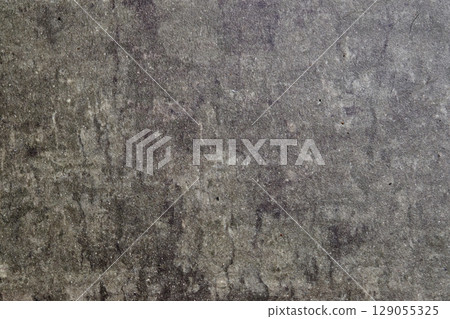 Textured surface resembling natural stone with variations in gray tones and subtle patterns visible under light 129055325