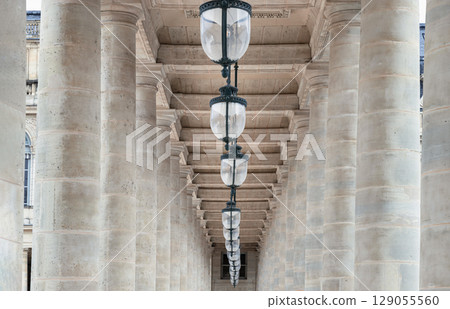Corridor perspective with Columns and Antique lantern hanging from Ceiling inside of the Courtyard of the Honor gallery. 129055560