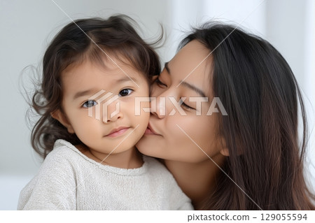 A serene and heartwarming moment showcasing a close-up of a mother embracing her child 129055594