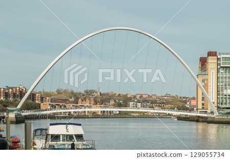 Beautiful scenery of The Iconic Gateshead millennium bridge spanning the River Tyne and Baltic flour mills with Magnificent sky in the background. 129055734