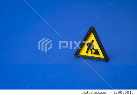 Sign men at work. Repairs and restoration work. Under construction. Road maintenance underway. Infrastructure upgrade ongoing. Temporary disruption expected. Utility servicing. Sign men at work. Repairs and restoration work. Under construction. Road maintenance underway. Infrastructure upgrade ongoing. Temporary disruption expected. Utility servicing. 129056013