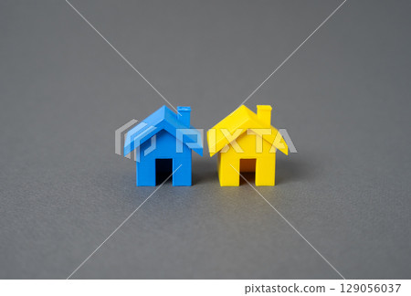 Houses in the colors of the Ukrainian flag. Care and support for Ukrainian refugees. Restoration of buildings and infrastructure. Temporary shelter. Recovery plans. 129056037