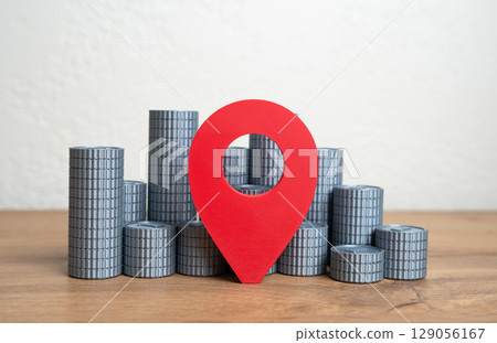 Geolocation symbol and stack of coins. Financial center. Financial hubs, regional investment potential. Digital economy zones, urban business concentration, and economic mapping. 129056167
