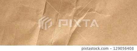 Crumpled old brown wrapping paper with aged folds and rough wrinkles. Abstract background Crumpled old brown wrapping paper with aged folds and rough wrinkles. Abstract background 129056408