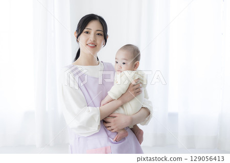 Baby lying on bed 129056413