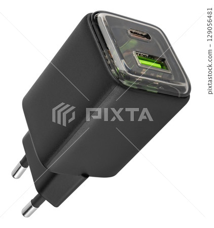 Classic white power adapter with USB port. on white background in insulation 129056481