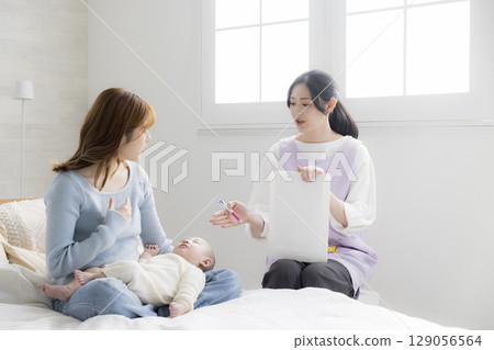 A young mother consulting a public health nurse A young mother consulting a public health nurse 129056564