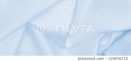 Smooth elegant blue silk or satin luxury cloth texture as abstract background. Luxurious background design 129056710