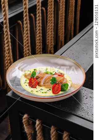 A refined main course featuring perfectly cooked duck breast slices laid over a bed of creamy mashed potatoes 129058131