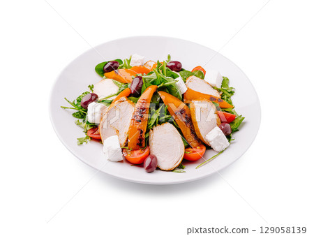 Grilled chicken salad with fresh vegetables and feta cheese served in a bowl Grilled chicken salad with fresh vegetables and feta cheese served in a bowl 129058139