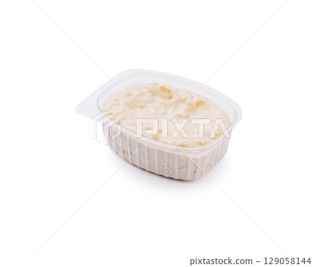 Creamy rice pudding with a hint of vanilla served in a plastic container 129058144