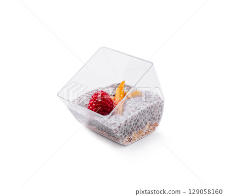 Chia seed pudding topped with raspberry and orange slice in clear cup Chia seed pudding topped with raspberry and orange slice in clear cup 129058160