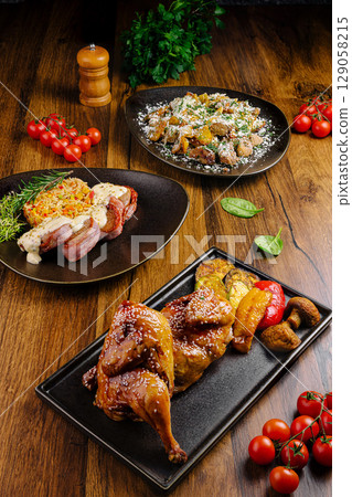 Delicious gourmet dishes arranged on a wooden table with vibrant ingredients Delicious gourmet dishes arranged on a wooden table with vibrant ingredients 129058215