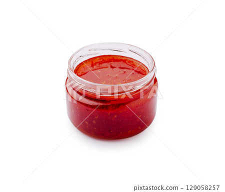 Spicy red sauce in a clear jar ready for culinary delights Spicy red sauce in a clear jar ready for culinary delights 129058257