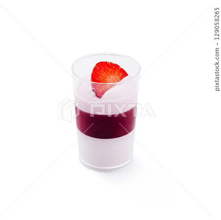 Delightful layered dessert served in clear glass with fresh strawberry 129058265