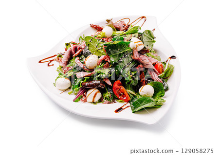 Fresh salad with greens, roasted meat, and cherry tomatoes beautifully arranged Fresh salad with greens, roasted meat, and cherry tomatoes beautifully arranged 129058275