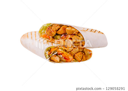 Delicious grilled chicken wraps filled with fresh vegetables and sauce 129058291
