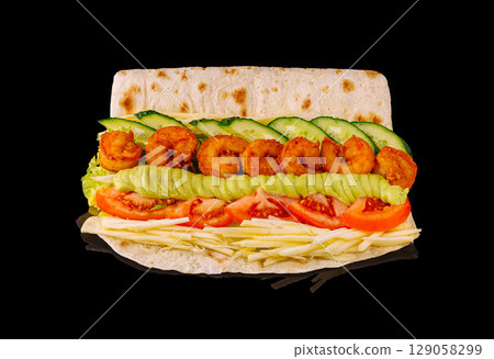 Delicious shrimp sandwich with fresh vegetables and sauces on a flatbread Delicious shrimp sandwich with fresh vegetables and sauces on a flatbread 129058299