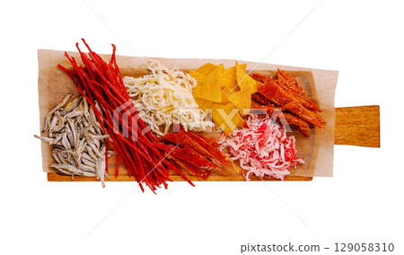 Variety of traditional snacks displayed on a wooden board in a casual setting Variety of traditional snacks displayed on a wooden board in a casual setting 129058310