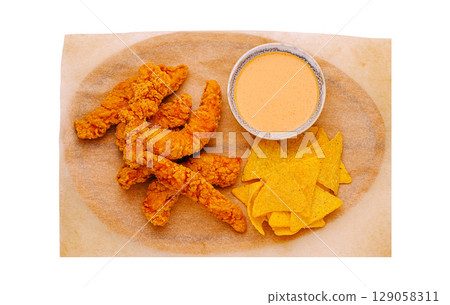 Crispy chicken or shrimp strips and nachos served with creamy sauce at a casual eatery 129058311