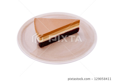 Delicious layered dessert with chocolate and cream on a white plate Delicious layered dessert with chocolate and cream on a white plate 129058411