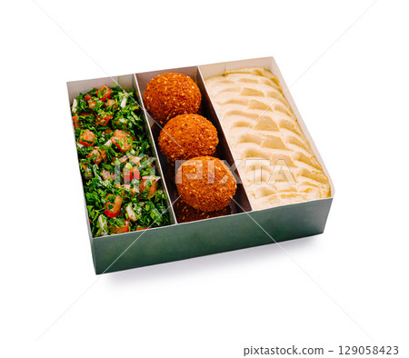 Delicious Middle Eastern platter with fresh tabbouleh and savory kebbeh 129058423